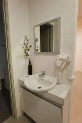 a white bathroom with a sink and a mirror at G Residence - 2R2B Barrington Night Market (2) in Brinchang