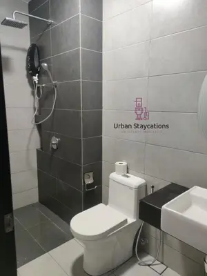 a bathroom with a white toilet and a sink at Urban Suites Homestay WL COSY in Jelutong