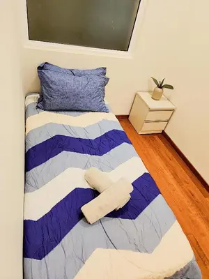 a bedroom with a bed with two towels on it at IPOH All Suite Resort, Jalan Haven, Persiaran Lembah Perpaduan, Ipoh in Ipoh