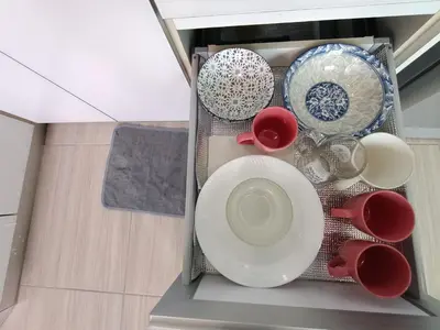 a pile of plates and bowls in a dishwasher at Awesome Suites 1, Netflix, Georgetown in Jelutong