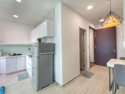 a kitchen with a refrigerator and a dining room at Awesome Suites 1, Netflix, Georgetown in Jelutong