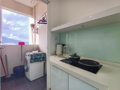 a kitchen with a sink and a washing machine at Awesome Suites 1, Netflix, Georgetown in Jelutong
