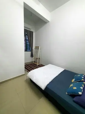 a bedroom with a bed and a ladder in it at Homestay Pohon Rendang in Balik Pulau