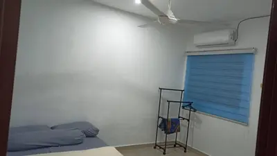 a bedroom with a bed and a ceiling fan at TokBi Homestay Gerik in Gerik