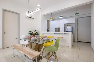 a kitchen and dining room with a table and chairs at The Jazz Serviced Suites in Tanjong Tokong