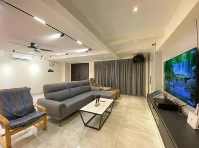 a living room with a couch and a flat screen tv at Brand New Premium House & Karaoke @BM Near Iconcity in Bukit Mertajam