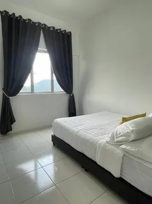 a bedroom with a bed and a window at Hanna Homestay Apartment for Muslim in Tanah Rata