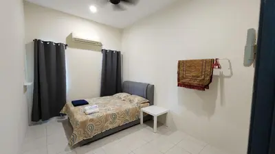 a hospital room with a bed and a table at Homestay LK in Sitiawan
