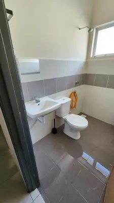 a bathroom with a toilet and a sink at Homestay LK in Sitiawan
