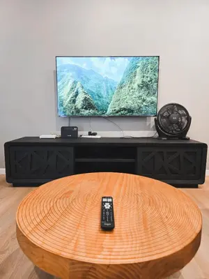 a television with a remote control sitting on a table at Spacious Corner Landed House Golden Hills Night Market in Brinchang