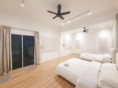 a bedroom with two beds and a ceiling fan at Spacious Corner Landed House Golden Hills Night Market in Brinchang