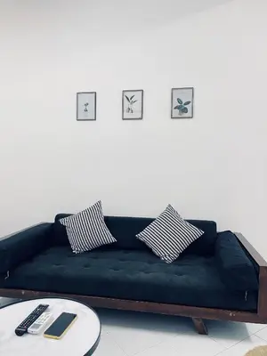 a black couch in a living room with a table at Comfort Semi D House, 1 min to Town by Mr Homestay in Teluk Intan