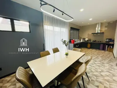 a dining room with a white table and chairs at Ipoh 19A Villa for 12pax 6 Carpark with BBQ by IWH in Ipoh