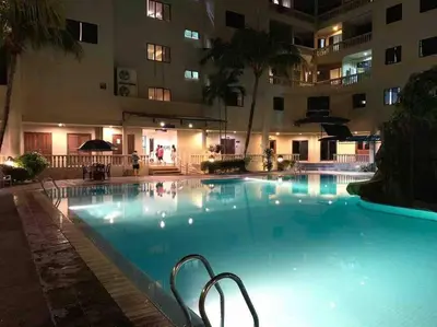 a large swimming pool in a hotel at night at Pangkor Island CoralBay Private Apartment in Pasir Bogak