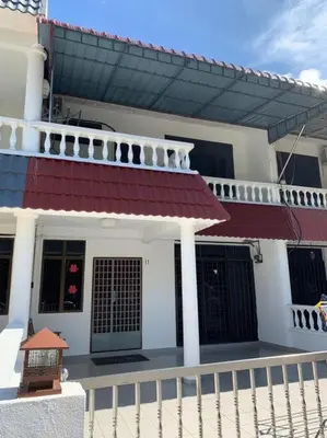 a white house with a gate and a fence at Pangkor Island Seaside @ 4 rooms Homestay in Pasir Bogak