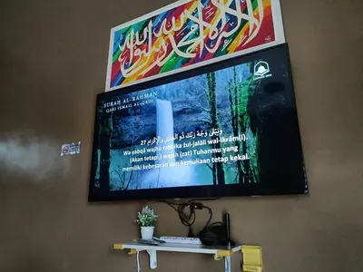 a flat screen tv hanging on a wall at Studio Teratak Alisha Permatang Pauh in Permatang Pauh