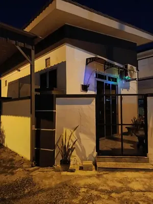 a house with a front door at night at Studio Teratak Alisha Permatang Pauh in Permatang Pauh