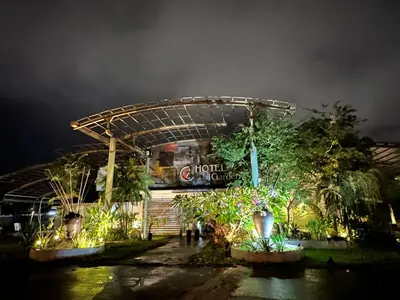 a hotel with a sign in front of it at night at I Garden Hotel in Ipoh