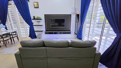 a living room with a couch and a television at Homestay By MSH Seri Iskandar in Seri Iskandar