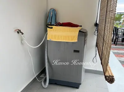 a trash can with a yellow towel on top of it at Haven Homestay\u6676\u6676\u5c4b (Brand New Homestay!) in Kampong Sungai Udang