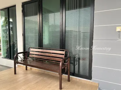 a wooden bench sitting in front of a window at Haven Homestay\u6676\u6676\u5c4b (Brand New Homestay!) in Kampong Sungai Udang