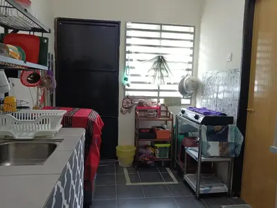a kitchen with a sink and a counter top at Homestay Kak Ninie in Teluk Intan