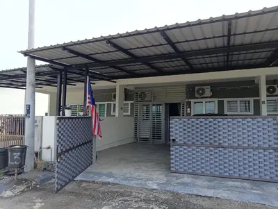 a building with awning and a fence in front at Homestay Kak Ninie in Teluk Intan