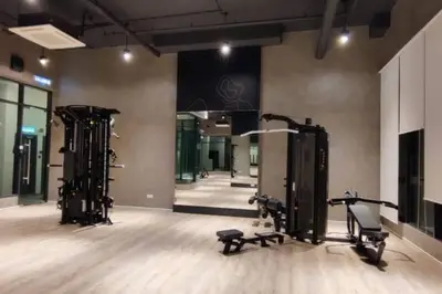 a gym with two treadmills and machines in a room at H&W Sunway Onsen Suite Tambun Sunway City Ipoh in Ipoh
