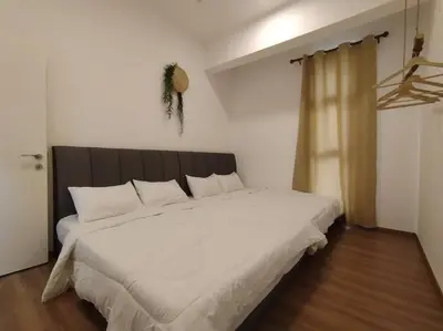 a bedroom with a large bed with white sheets at be.Bamboo The Cove-6mins Lost World Tambun-10pax in Ipoh