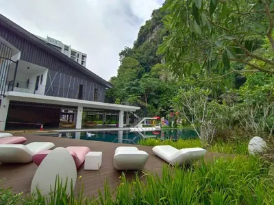 a patio with chairs and a pool in front of a building at be.Cream The Cove -6mins Lost World Tambun -10pax in Ipoh