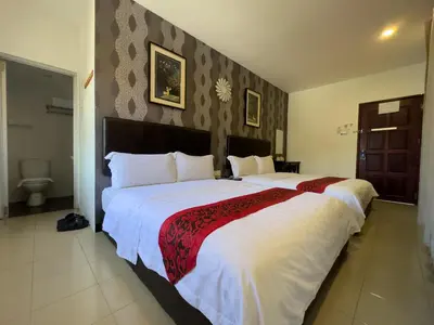 a bedroom with a large bed with white sheets at Inn Residence 18 in George Town