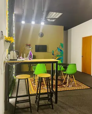 an office with a table and green stools at AK Greenrise Meru in Ipoh
