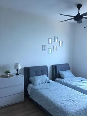a bedroom with two beds and a blue light at New! Batu Ferringhi Seaview Cozy Condo, Penang in Batu Ferringhi