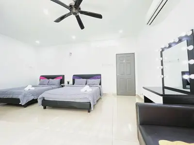 a bedroom with two beds and a ceiling fan at KawanMu House with 6 Bedrooms in Taiping