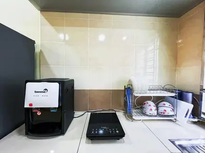 a laptop computer sitting on top of a counter at KawanMu House with 6 Bedrooms in Taiping