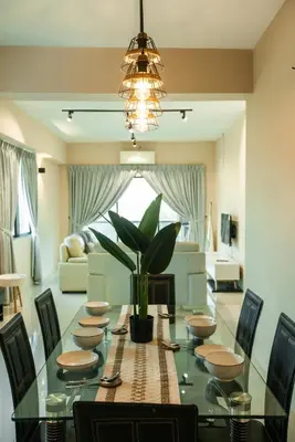a dining room with a table with a potted plant at Stylish River-View Apartment In Ipoh in Ipoh