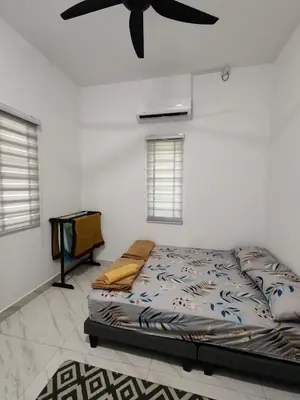 a bedroom with a bed and a ceiling fan at Homestay Tepi Sungai Perak in Kuala Kangsar
