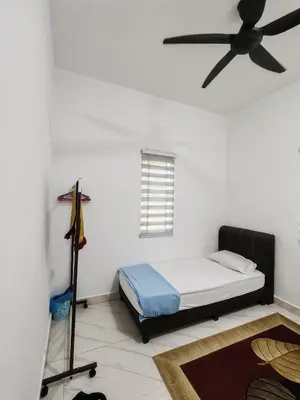 a bedroom with a bed and a ceiling fan at Homestay Tepi Sungai Perak in Kuala Kangsar