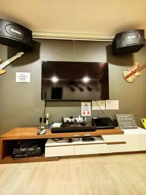 a room with a counter with a television on a wall at Ocean Private Pool Homestay Ipoh \u6d77\u6d0b\u98ce\u60c5\u6cf3\u6c60\u6c11\u5bbf 14px\uff08Wellsonhome\uff09 in Ipoh