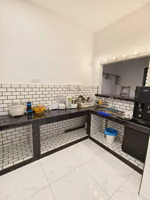 a kitchen with a counter top with many appliances at Ocean Private Pool Homestay Ipoh \u6d77\u6d0b\u98ce\u60c5\u6cf3\u6c60\u6c11\u5bbf 14px\uff08Wellsonhome\uff09 in Ipoh