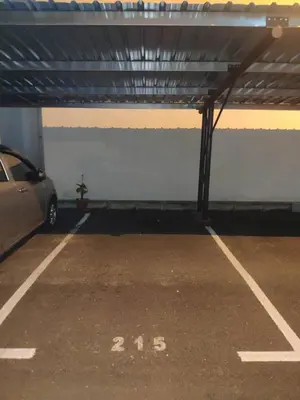 a parking garage with a car parked in it at 3 Bedroom Apartment with Pool and Beautiful View in Klebang, Ipoh in Chemor