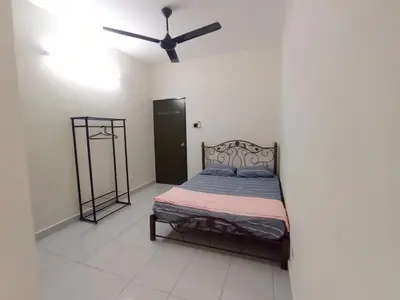 a bedroom with a bed with a ceiling fan at A&H Homestay Teluk Senangin in Segari