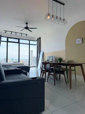 a living room with a couch and a dining room table at Beacon Executive Suite by Uptrend Home Management in George Town