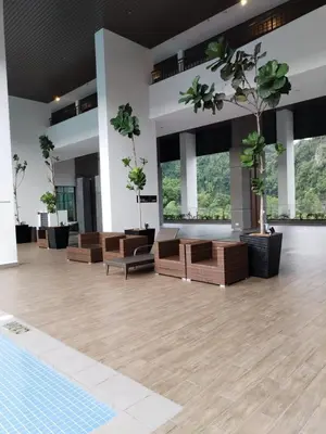 a large empty room with chairs and potted plants at Sunway Onsen 4-5pax in Kampong Batu Lapan