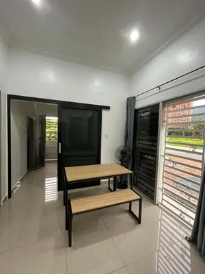 a wooden table and a bench in a room at Manong Kuala Kangsar Homestay Chegu Wok in Manong
