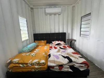 a bedroom with a bed with colorful blankets at Slim Village Palm House - 2 rooms, 8 beds, 8 persons in Slim River