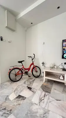 a red bike is parked in a room at 515 Nana’s Homes in Sekinchan in Sekincan