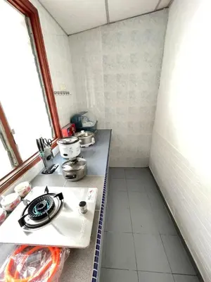 a kitchen with a counter with pots and pans on it at Happy Gather Homestay \u6b22\u805a\u9601 in Ipoh