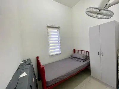 a small bedroom with a bed and a window at Rumah Kami Homestay in Butterworth