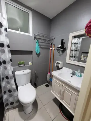 a bathroom with a white toilet and a sink at NICE and COZY studio apartment with gym and pool. in Kampar